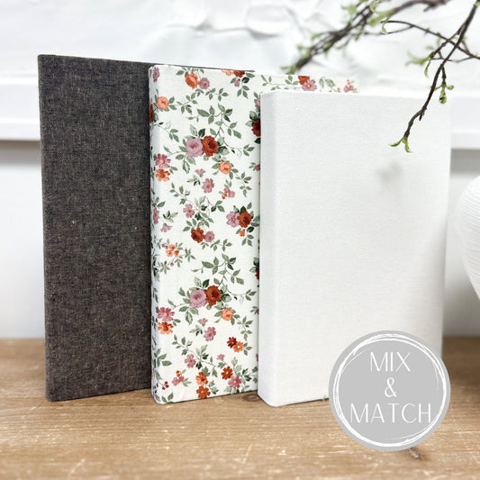 Fabric covered books for shelf decor.